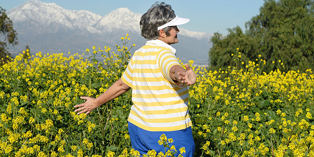 Elderly woman standing in a meadow
