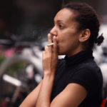 African American Woman Lights Up a Cigarette